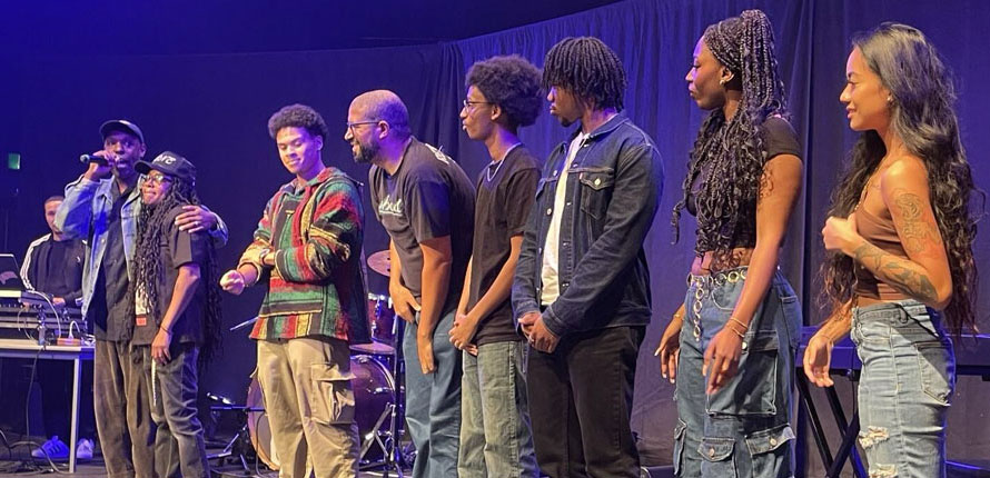 A group of students on stage at a concert